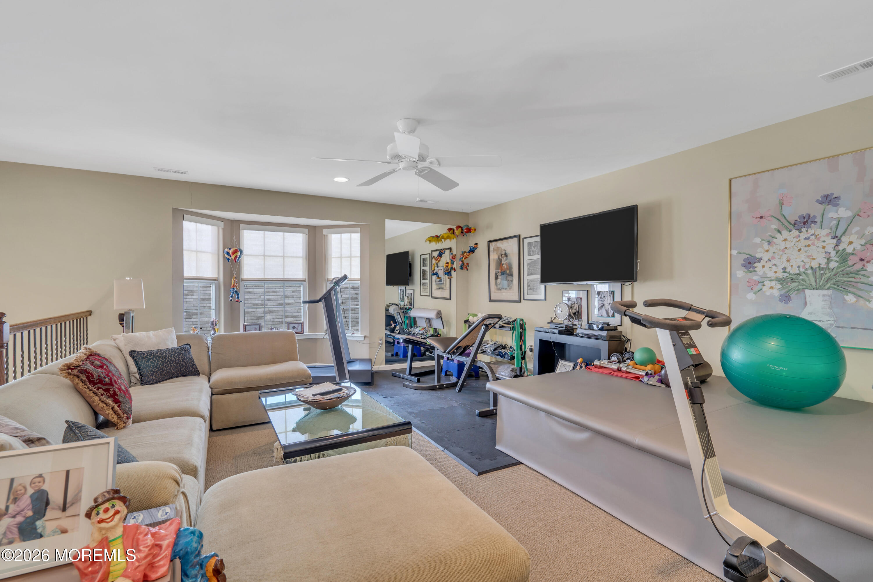 15 Enclave Boulevard Lakewood, NJ 08701 - Photo 49 of 81 a living room with furniture and a flat screen tv