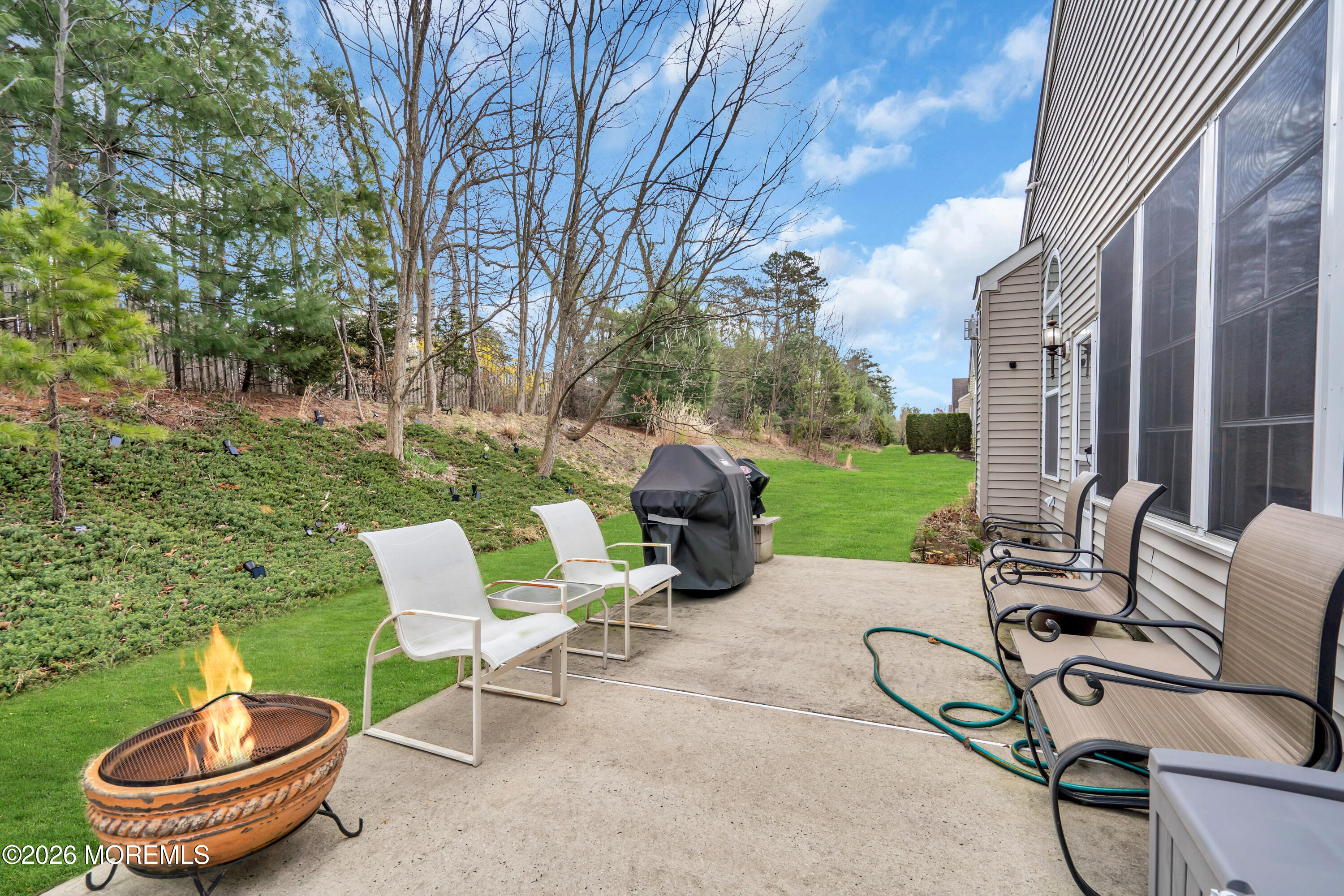 15 Enclave Boulevard Lakewood, NJ 08701 - Photo 64 of 81 a view of a patio with table and chairs potted plants and a large tree