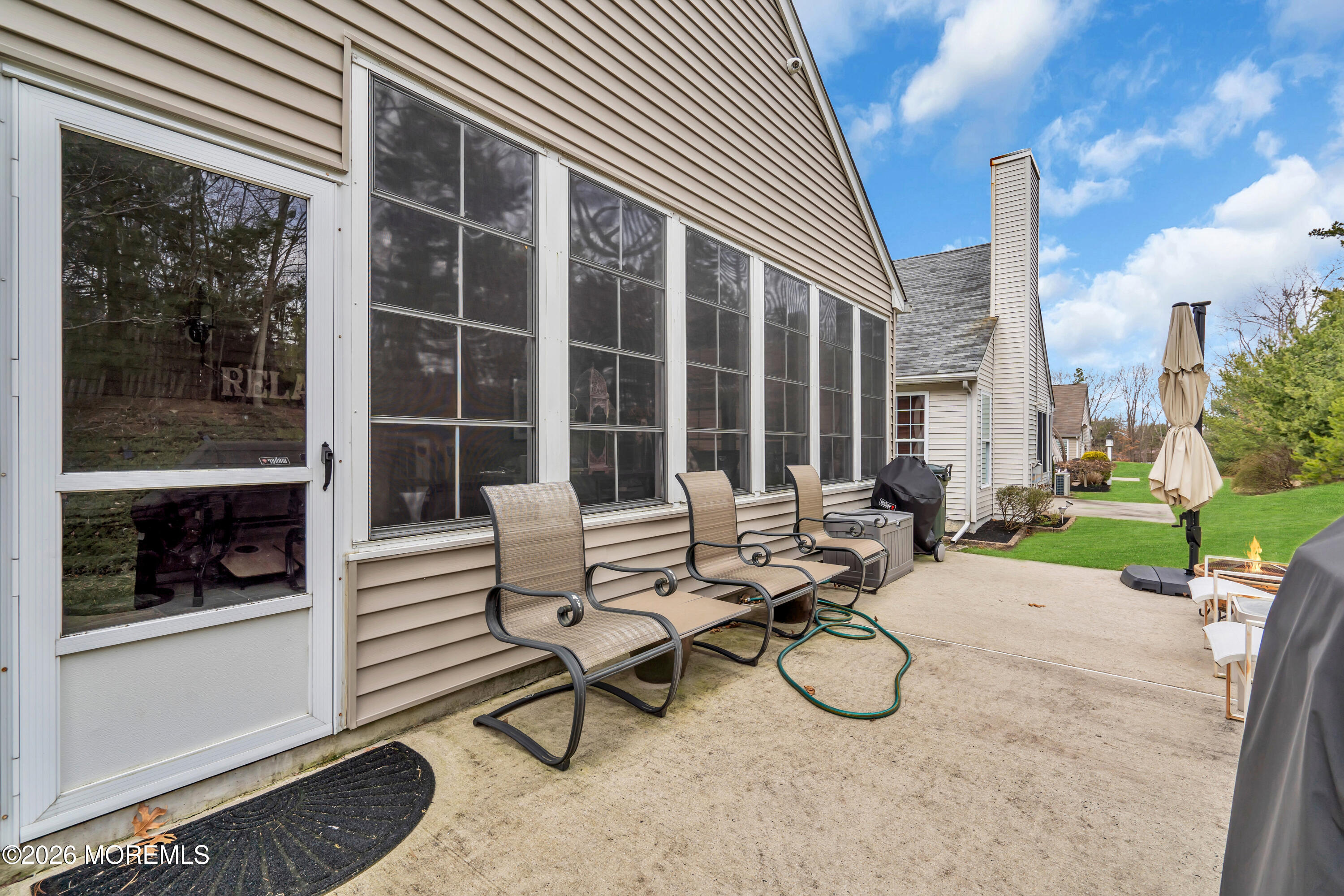15 Enclave Boulevard Lakewood, NJ 08701 - Photo 66 of 81 a view of a patio with table and chairs and potted plants