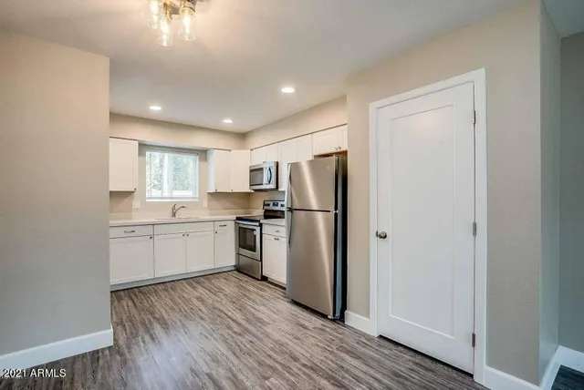 a kitchen with stainless steel appliances a refrigerator sink and microwave