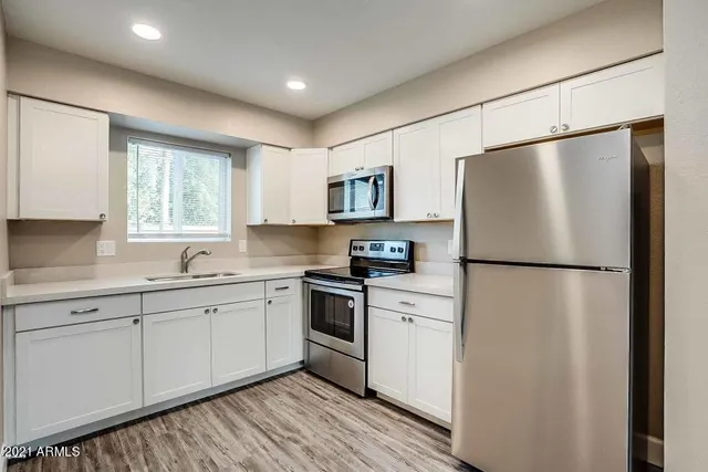 a kitchen with stainless steel appliances granite countertop a stove and a microwave