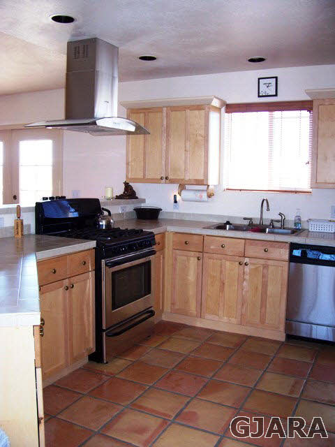 20258 Fox Ridge Drive Austin, CO 81410 - Photo 5 of 6 a kitchen with stainless steel appliances a stove a sink and a microwave