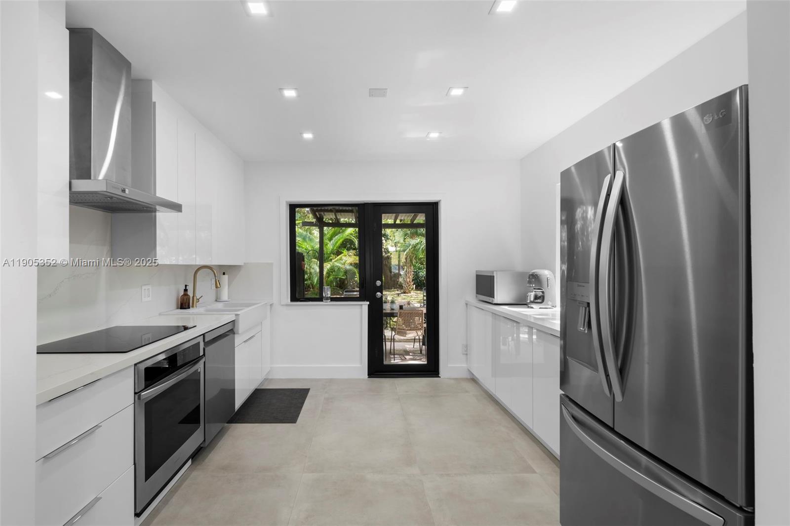 829 Southwest 4th Court Fort Lauderdale, FL 33312 - Photo 3 of 12 a kitchen with stainless steel appliances granite countertop a refrigerator a stove and a sink