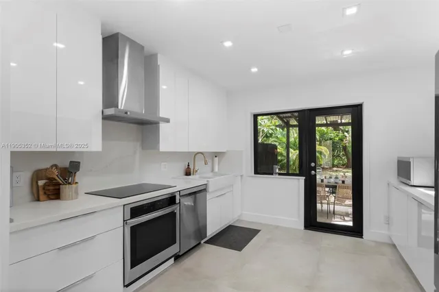 a kitchen with stainless steel appliances a sink stove and cabinets