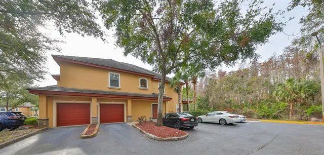 a car parked in front of a white house