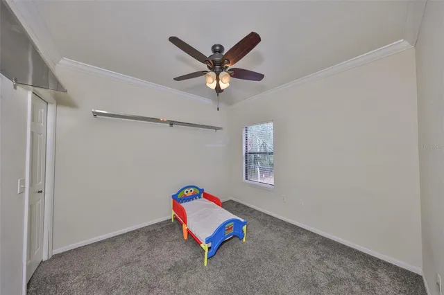 a living room with couch and a ceiling fan