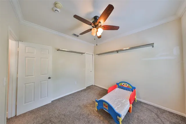 a room with a fan and a ceiling fan