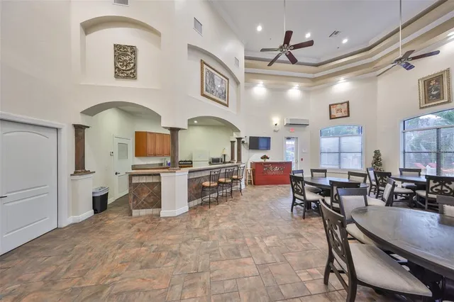 a kitchen with cabinets and chairs