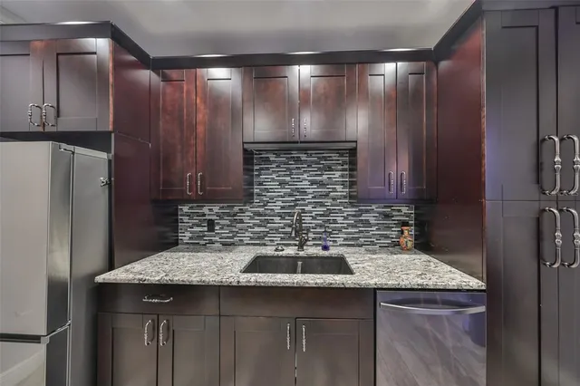 a kitchen with a sink and cabinets