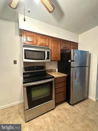 a kitchen with cabinets and stainless steel appliances