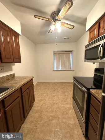 a kitchen with stainless steel appliances granite countertop a stove and a sink