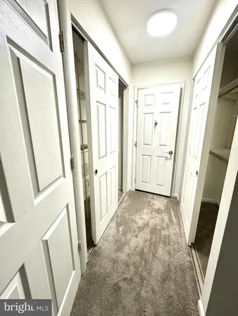 a view of an entryway with white walls and door