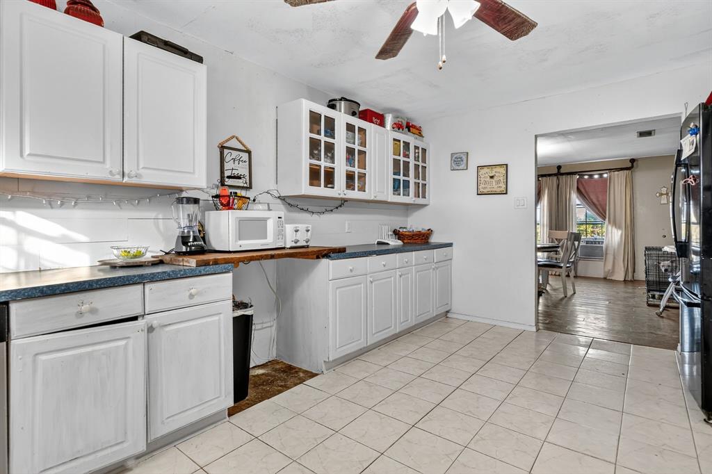 511 Salt Creek Road Poolville, TX 76487 - Photo 14 of 29 a kitchen with cabinets and chairs