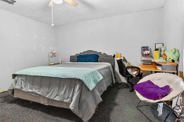 a bedroom with a bed a couch and dresser