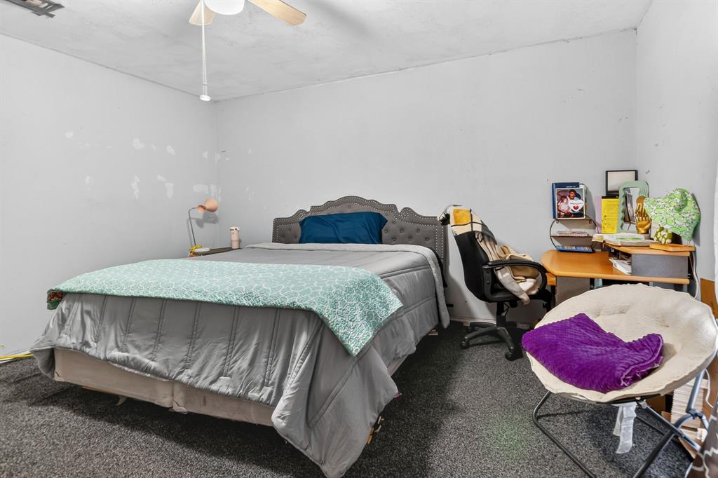 511 Salt Creek Road Poolville, TX 76487 - Photo 17 of 29 a bedroom with a bed a couch and dresser