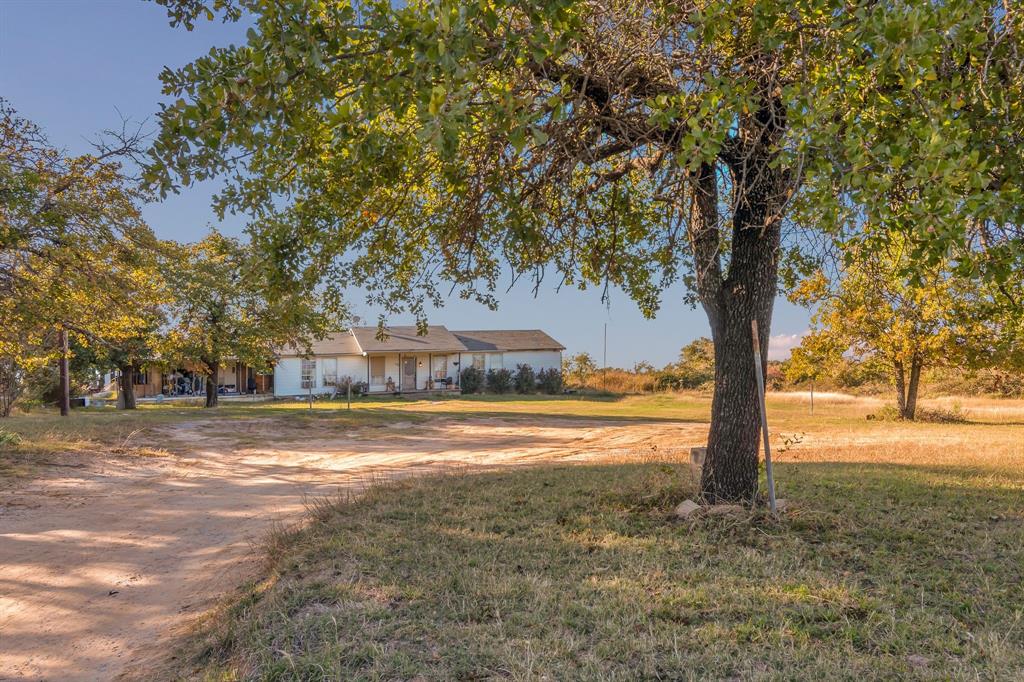 511 Salt Creek Road Poolville, TX 76487 - Photo 2 of 29 a view of a yard with large trees
