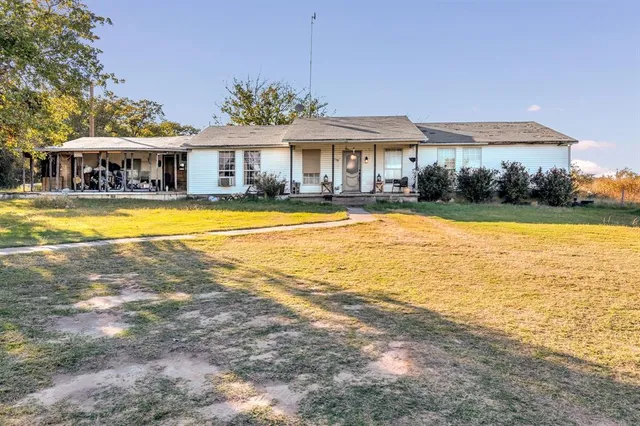 a front view of a house with swimming pool and porch