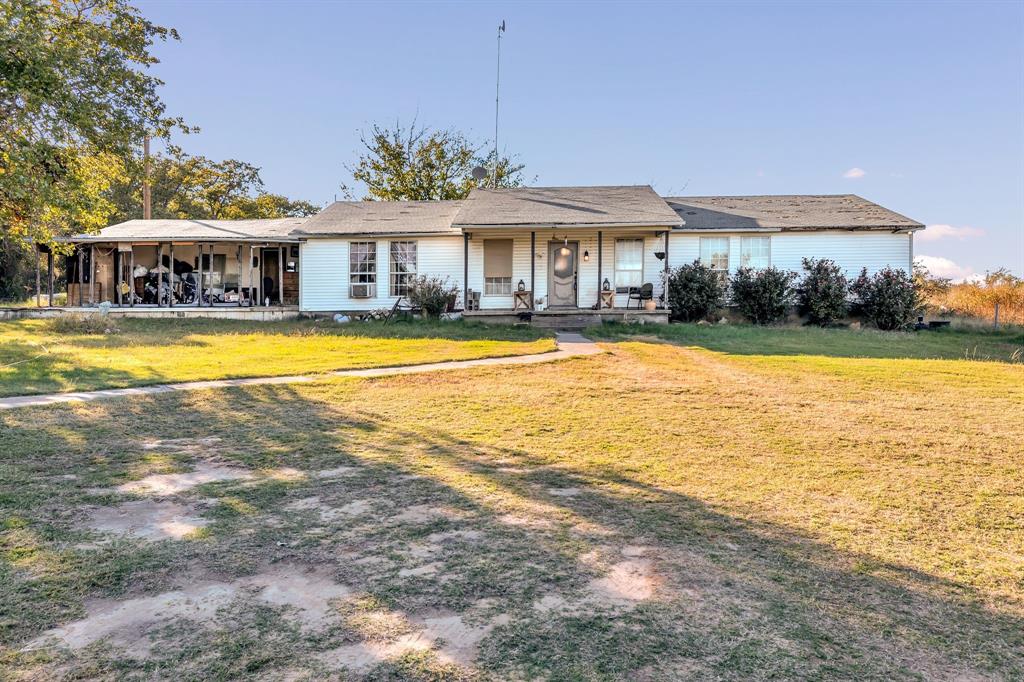 511 Salt Creek Road Poolville, TX 76487 - Photo 4 of 29 a front view of a house with swimming pool and porch