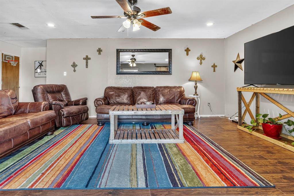 511 Salt Creek Road Poolville, TX 76487 - Photo 6 of 29 a living room with furniture and a flat screen tv