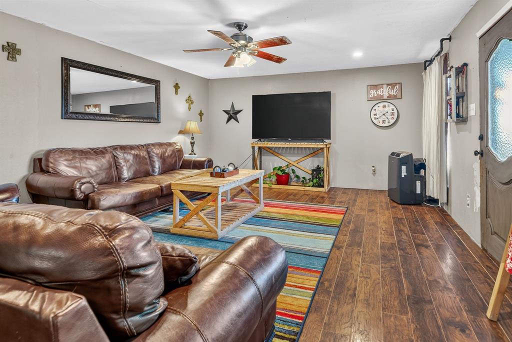 511 Salt Creek Road Poolville, TX 76487 - Photo 7 of 29 a living room with furniture and a flat screen tv