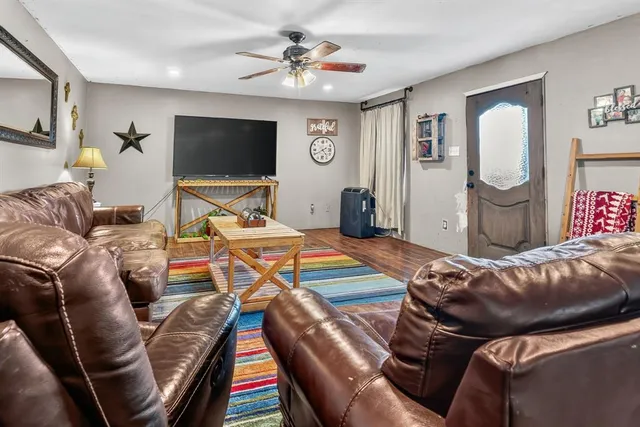 a living room with furniture and a flat screen tv