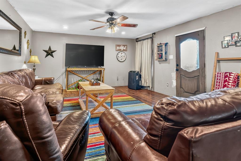 511 Salt Creek Road Poolville, TX 76487 - Photo 8 of 29 a living room with furniture and a flat screen tv