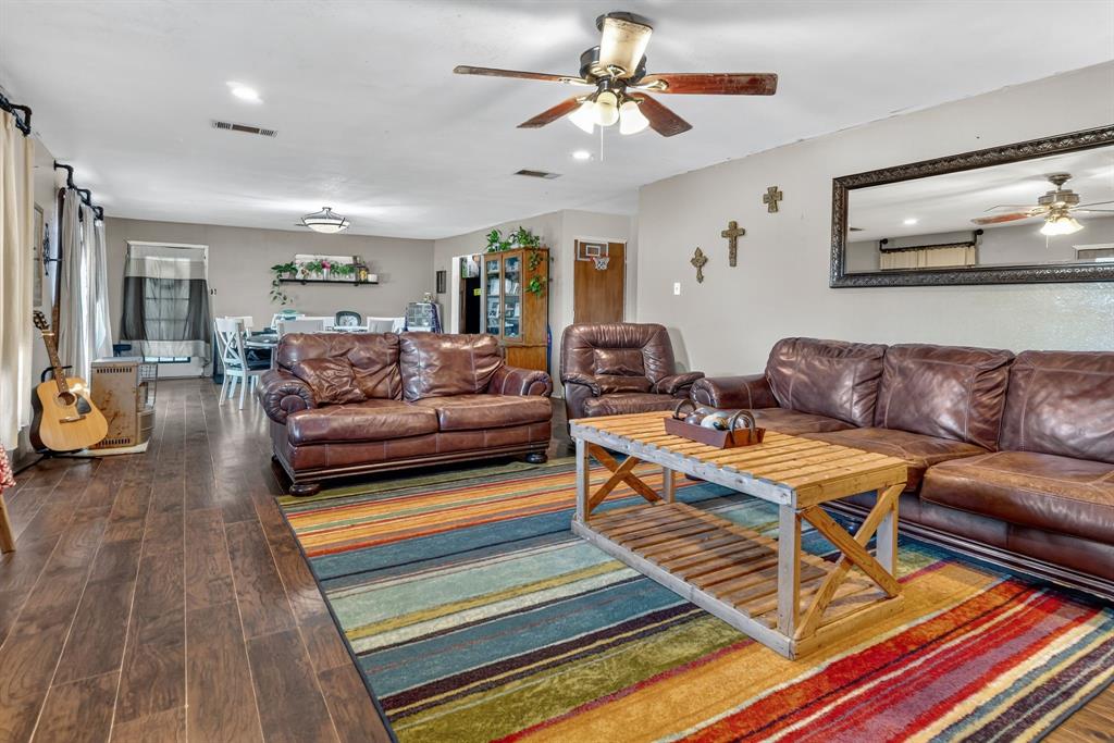 511 Salt Creek Road Poolville, TX 76487 - Photo 9 of 29 a living room with furniture a rug and a flat screen tv