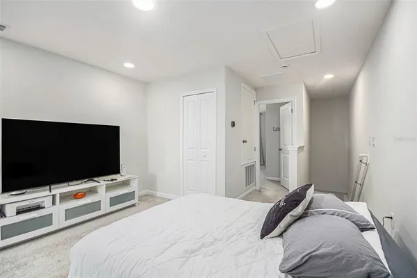 a bedroom with a bed and a flat screen tv