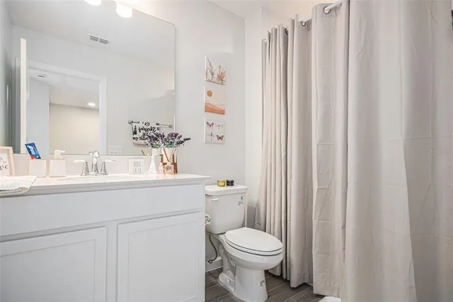 a bathroom with a toilet a sink and a mirror