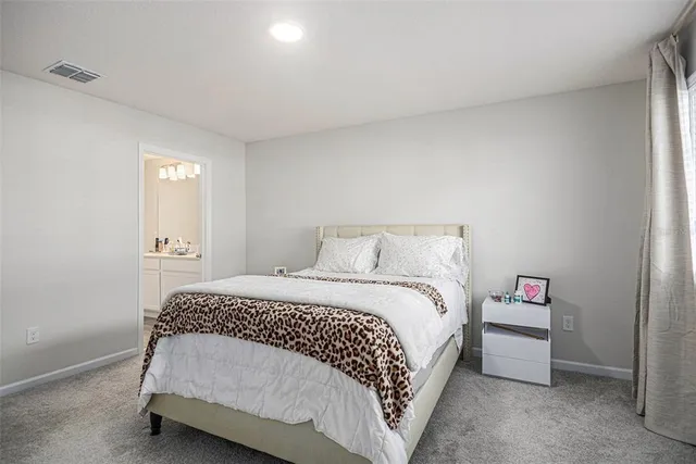 a bedroom with a bed and a lamp