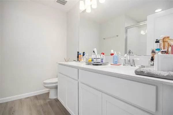 a bathroom with a sink a toilet and a mirror