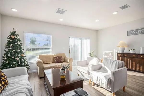 a living room with furniture and a christmas tree