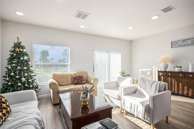 a living room with furniture and a christmas tree
