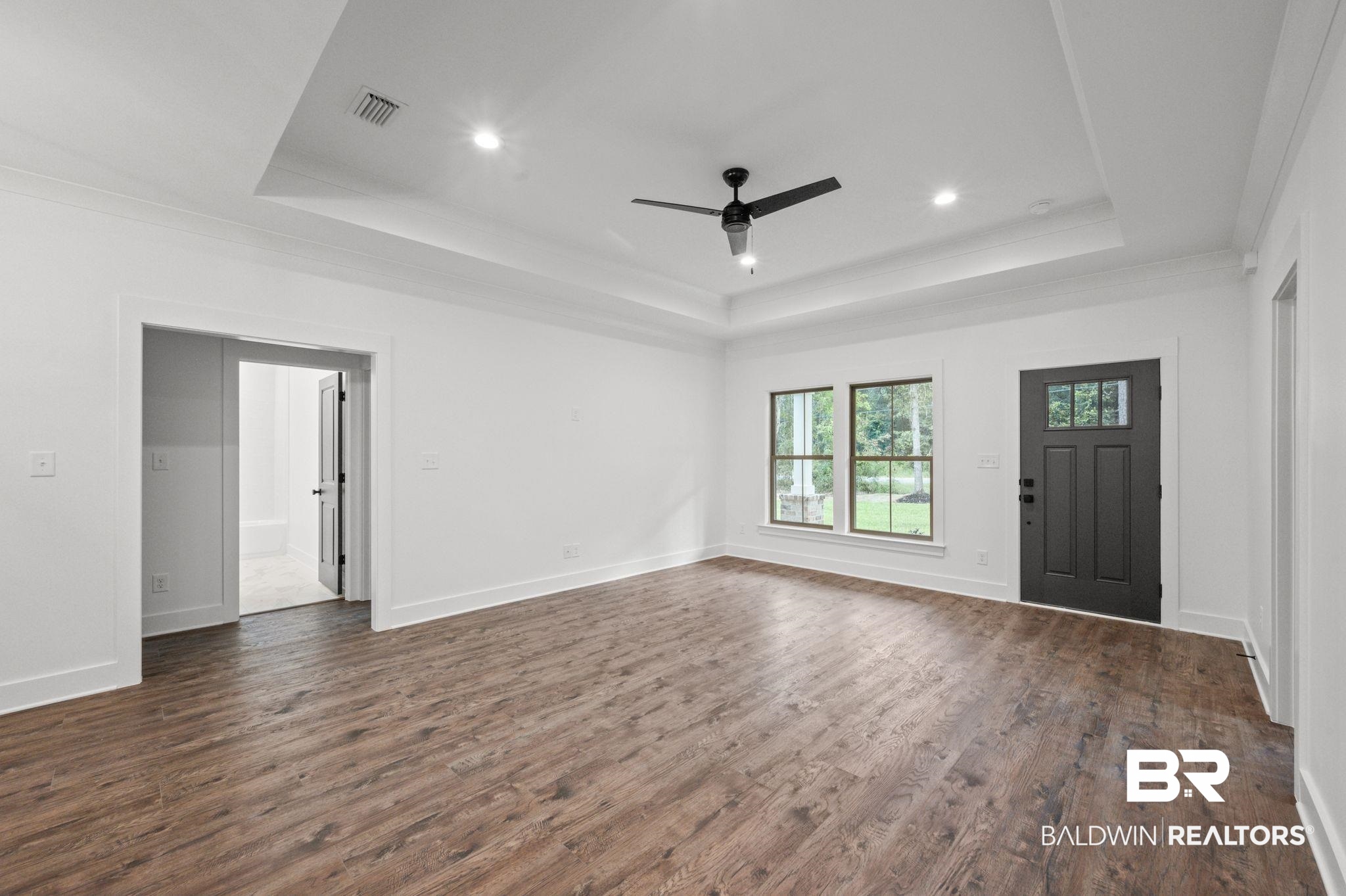 12412 Mannich Lane Foley, AL 36535 - Photo 23 of 23 Foyer with ceiling fan, a raised ceiling, and wood-type flooring
