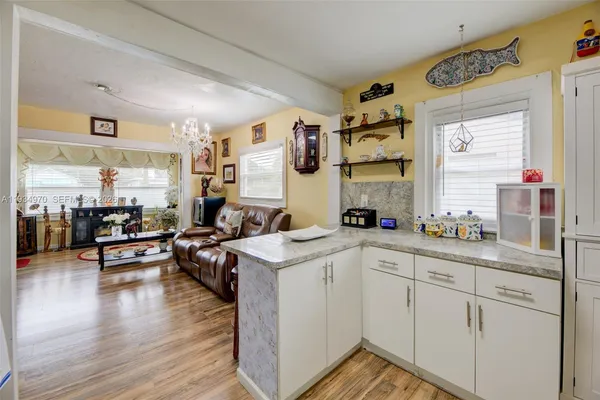 a kitchen with sink cabinets and wooden floor