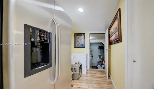 a view of a hallway view with wooden floor and living room