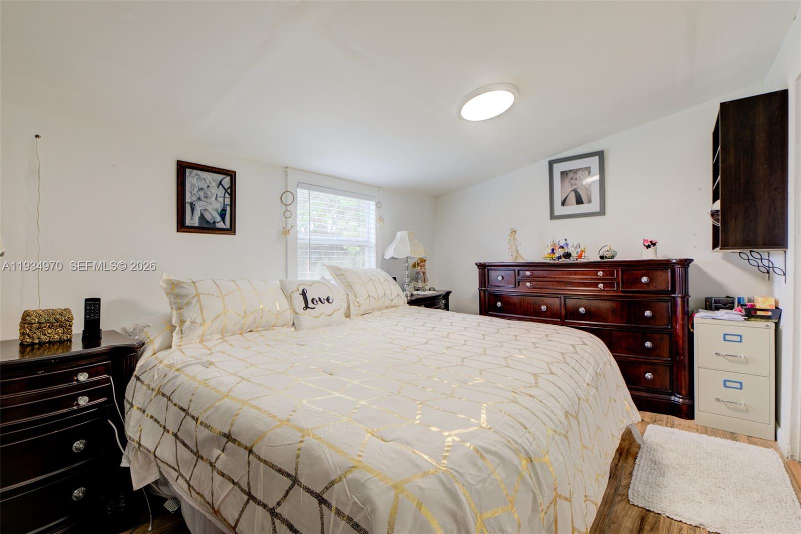 1911 Northwest 52nd Street Miami, FL 33142 - Photo 15 of 48 a bedroom with a bed and a flat screen tv