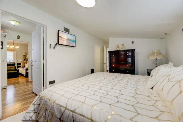 a bedroom with a bed and a mirror