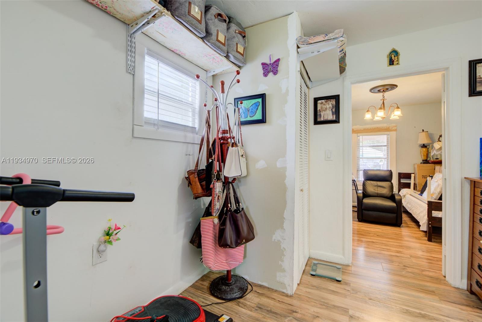 1911 Northwest 52nd Street Miami, FL 33142 - Photo 18 of 48 a view of entryway with livingroom and wooden floor