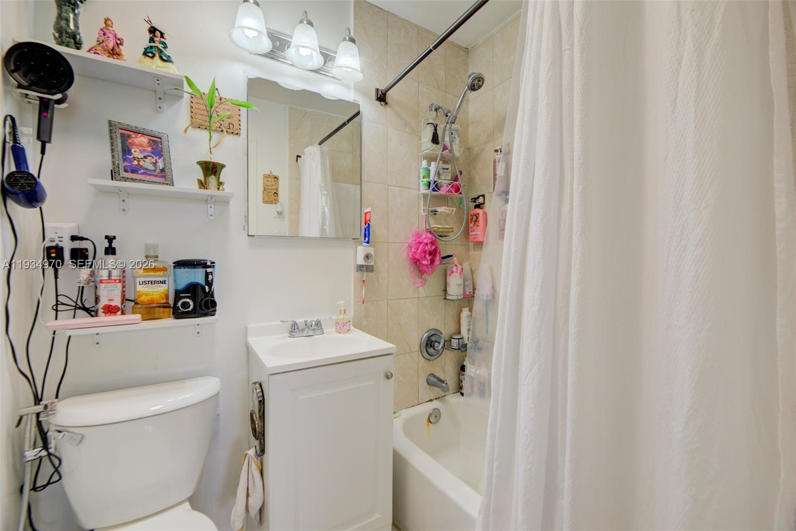 1911 Northwest 52nd Street Miami, FL 33142 - Photo 20 of 48 a bathroom with a sink toilet vanity and tub