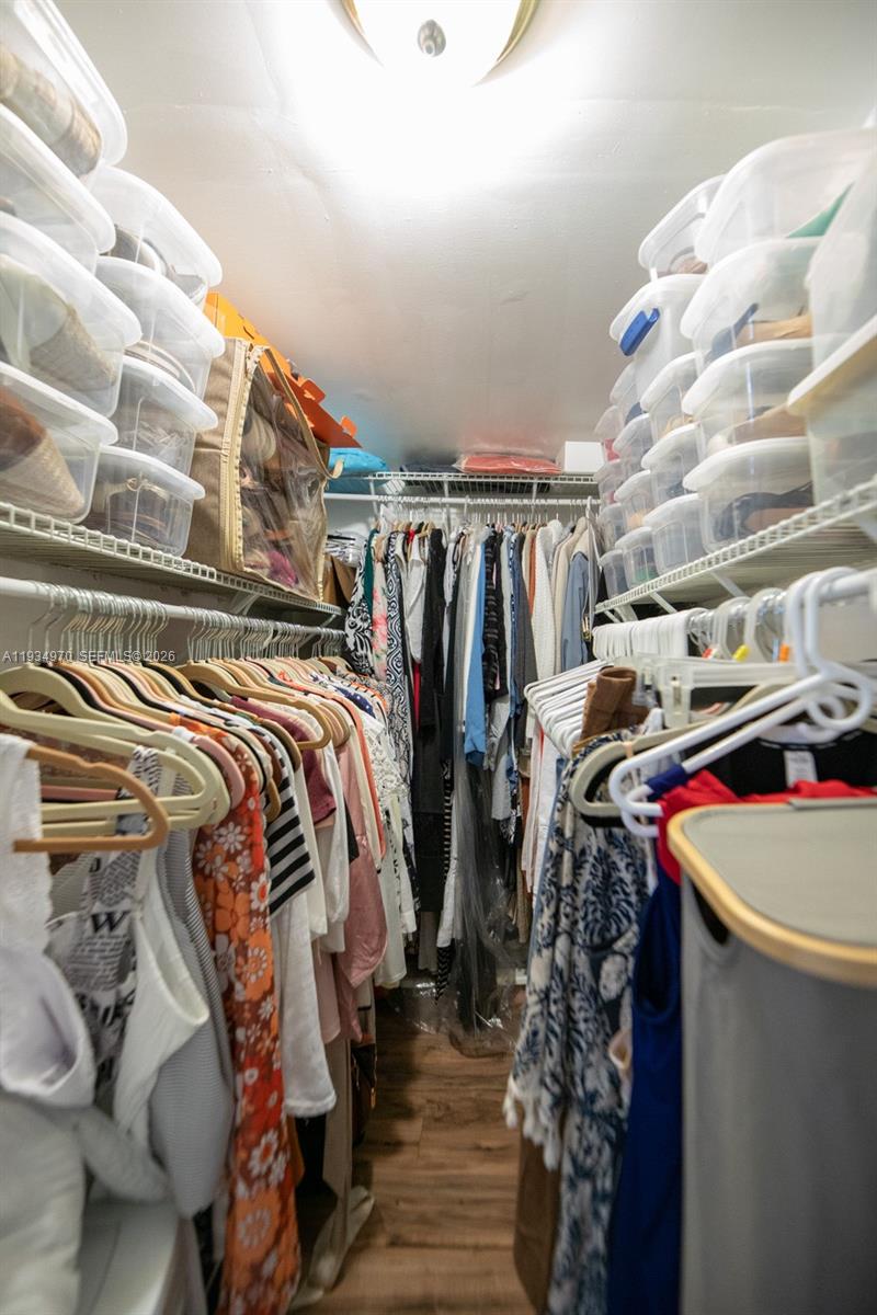 1911 Northwest 52nd Street Miami, FL 33142 - Photo 25 of 48 a view of walk in closet with clothes and shoes