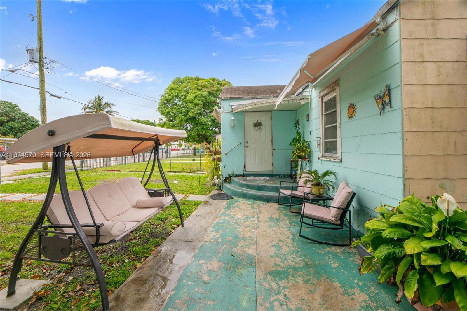 1911 Northwest 52nd Street Miami, FL 33142 - Photo 27 of 48 a backyard of a house with table and chairs