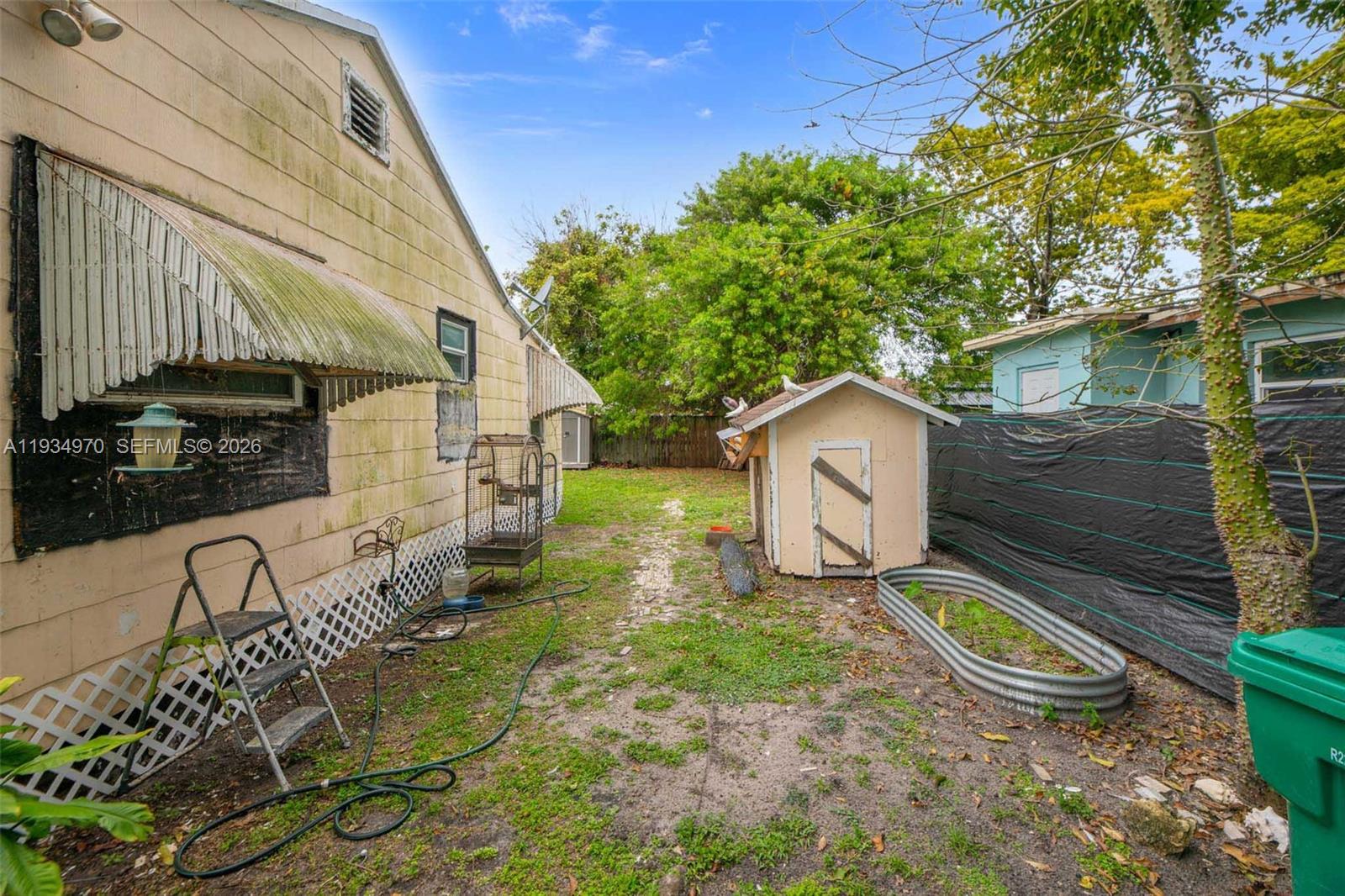 1911 Northwest 52nd Street Miami, FL 33142 - Photo 28 of 48 a house view with a garden space