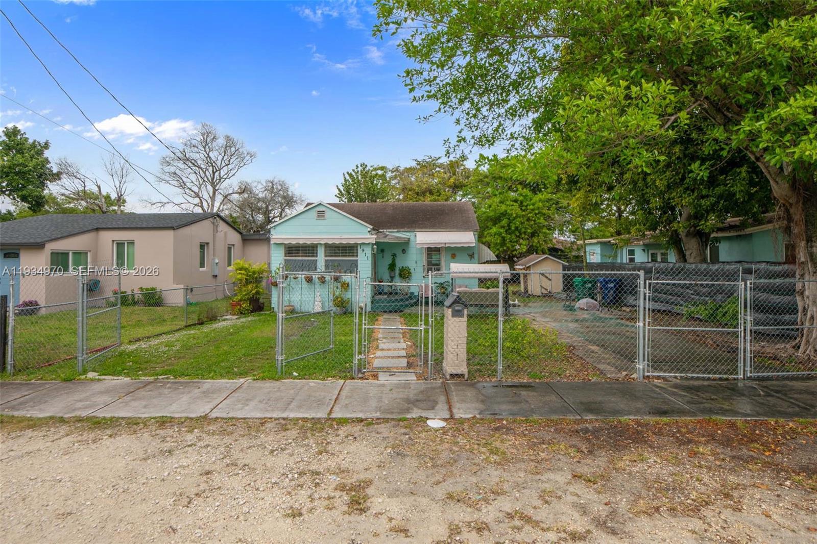 1911 Northwest 52nd Street Miami, FL 33142 - Photo 32 of 48 a view of house with a yard