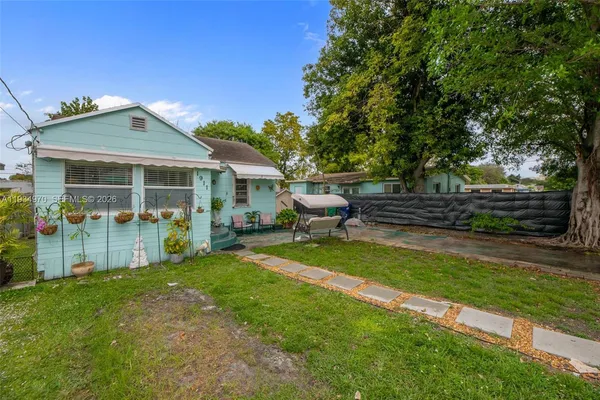 a backyard of a house with table and chairs