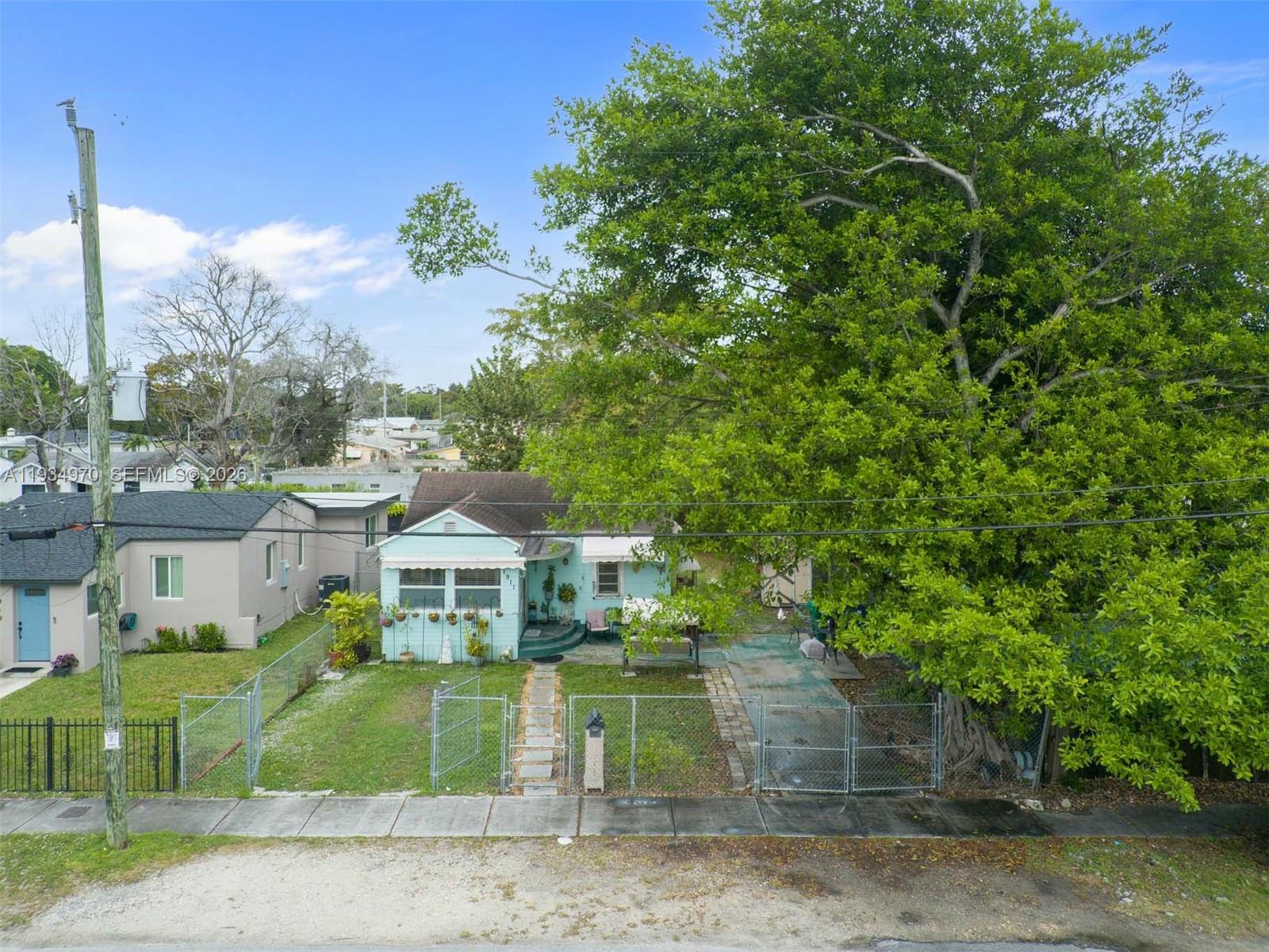 1911 Northwest 52nd Street Miami, FL 33142 - Photo 36 of 48 a front view of a house with a yard