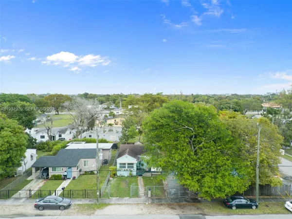 an aerial view of residential houses with city view