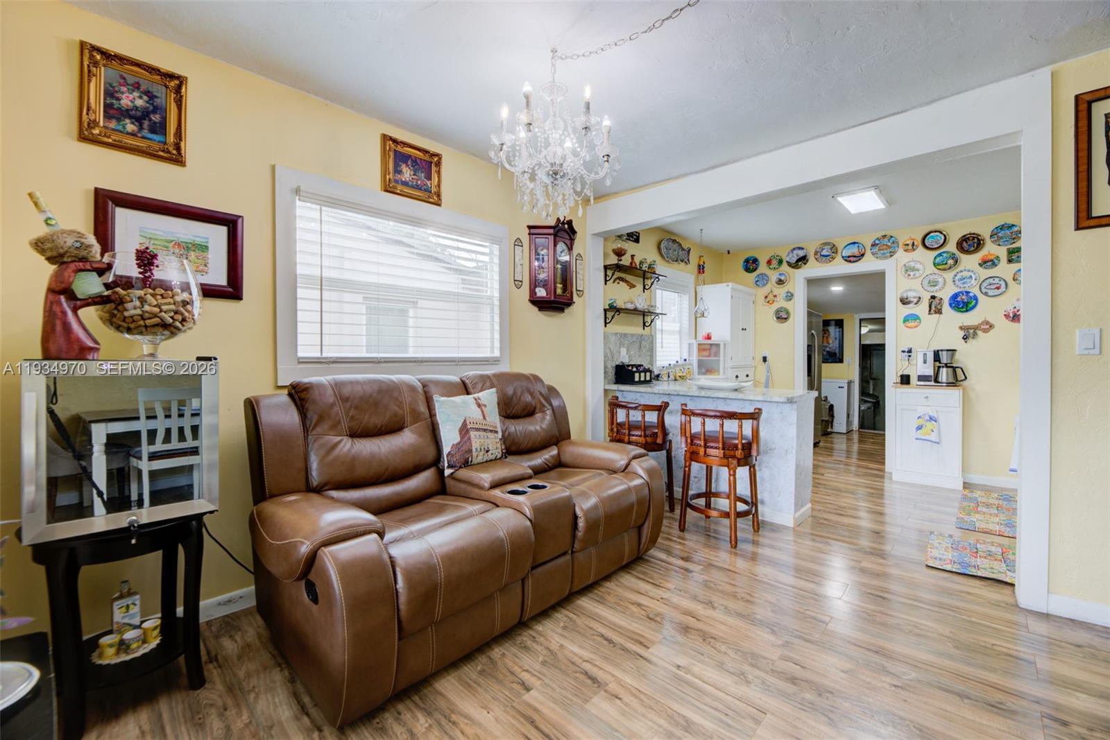 1911 Northwest 52nd Street Miami, FL 33142 - Photo 4 of 48 a living room with furniture a fireplace and wooden floor