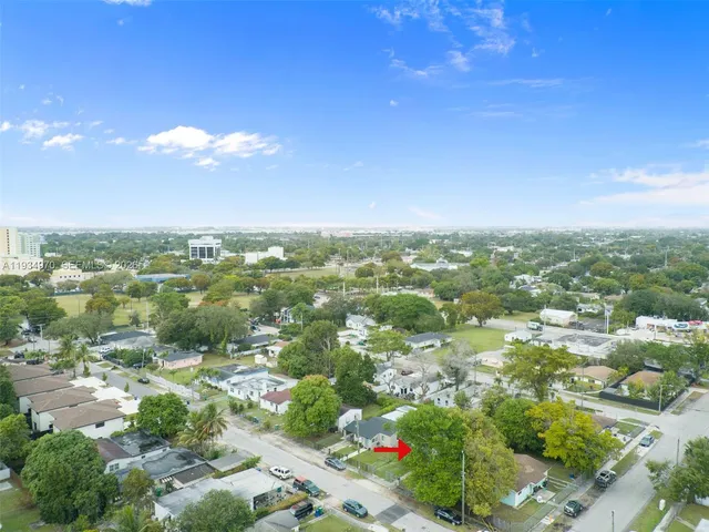 an aerial view of a house with a yard