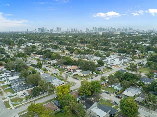an aerial view of residential building with green space